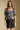 Front view of a woman wearing the Saltwater Luxe  Lemi Top on a neutral background with arms at sides