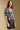Front view of a woman wearing the Saltwater Luxe  Lemi Top on a neutral background with leather skirt