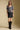 A full body front view of a woman wearing the Saltwater Luxe  Lemi Top on a neutral background