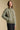 Side angle view of a woman wearing the Saltwater Luxe Levy Jacket on a neutral background with hand in pocket