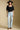 A full body front view of a woman wearing the Saltwater Luxe Lewis Top on a neutral background