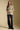 A full body front view of a woman wearing the Saltwater Luxe Liu Top on a neutral background