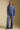A full body front view of a woman wearing the Saltwater Luxe Liu Indigo Top on a neutral background