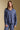 Front view of a woman wearing the Saltwater Luxe Liu Indigo Top on a neutral background with matching pants