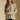Front view of a woman wearing the Saltwater Luxe Liu Top on a neutral background with hands clasped at waist