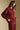 Side angle view of a woman wearing the Saltwater Luxe Long Sleeve Pullover on a neutral background with hands on hem