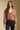 Front view of a woman wearing the Saltwater Luxe  Louis Sweater on a neutral background with petite necklace