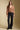 A full body front view of a woman wearing the Saltwater Luxe  Louis Sweater on a neutral background