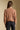 Back view of a woman wearing the Saltwater Luxe  Louis Sweater on a neutral background with pants