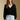 Front view of a woman wearing the Saltwater Luxe Louis Sweater on a neutral background with hands lowered