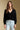 Front view of a woman wearing the Saltwater Luxe Louis Sweater on a neutral background with hands lowered