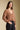 Side angle view of a woman wearing the Saltwater Luxe  Louis Sweater on a neutral background with black pants