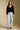 A full body front view of a woman wearing the Saltwater Luxe Louis Sweater on a neutral background