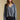 Front view of a woman wearing the Saltwater Luxe Lyrra Top on a neutral background with hands at sides