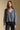 Front view of a woman wearing the Saltwater Luxe Lyrra Top on a neutral background with hands at sides