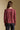 Back view of a woman wearing the Saltwater Luxe Lyrra Top on a neutral background with pants