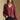 Front view of a woman wearing the Saltwater Luxe Lyrra Top on a neutral background with black pants and hand in pocket