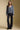 A full body front view of a woman wearing the Saltwater Luxe Lyrra Top on a neutral background