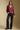 A full body front view of a woman wearing the Saltwater Luxe Lyrra Top on a neutral background