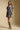 Front view of a woman wearing the Saltwater Luxe Malinda Mini Dress on a neutral background with brown boots