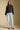 A full body front view of a woman wearing the Saltwater Luxe Margow Sweater on a neutral background