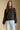 Front view of a woman wearing the Saltwater Luxe Margow Sweater on a neutral background with hands at sides