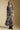A full body front view of a woman wearing the Saltwater Luxe Maud Midi Floral Skirt on a neutral background