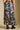 Back view of a woman wearing the Saltwater Luxe Maud Midi Floral Skirt on a neutral background with boots