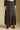 Front view of a woman wearing the Saltwater Luxe Maud Midi Skirt on a neutral background with matching top