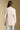 Back view of a woman wearing the Saltwater Luxe Maxine Simple Sweater on a neutral background with jeans