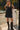 Front view of a woman wearing the Saltwater Luxe Miniya Mini Dress in front of the water