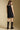 Back view of a woman wearing the Saltwater Luxe Miniya Mini Dress on a neutral background
