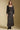 A full body front view of a woman wearing the Saltwater Luxe Nolla Midi Skirt on a neutral background