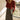 Front view of a woman wearing the Saltwater Luxe Nolla Midi Skirt with a cardigan