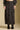 Front view of a woman wearing the Saltwater Luxe Nolla Midi Skirt on a neutral background with top