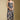 Front view of a woman wearing the Saltwater Luxe Novi Midi Dress and boots on a neutral background