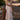 Front view of a woman wearing the Saltwater Luxe Peni Midi Dress on a woodland trail leaning on a post