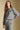 Front view of a woman wearing the Saltwater Luxe Perry Heather Grey Pullover on a neutral background with one hand on hip