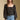 Front  view of a woman wearing the Saltwater Luxe on a neutral background with bluejeans and hands at sides