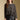 Front  view of a woman wearing the Saltwater Luxe on a neutral background with black skirt and hands at sides