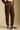 Side angle view of  a woman wearing the Saltwater Luxe Pull On Jogger on a neutral background with hand in pocket