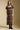Front view of a woman wearing the Saltwater Luxe Quinlie Midi Dress on a neutral background with black boots