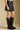 Side angle view of a woman wearing the Saltwater Luxe Ralie Skirt with knee high boots