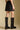 Back view of a woman wearing the Saltwater Luxe Ralie Skirt with boots