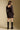 Back view of a woman wearing the Saltwater Luxe Ralph Mini Dress on a neutral background