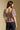 Back view of a woman wearing the Saltwater Luxe Robyn Top on a neutral background