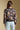 Back view of a woman wearing the Saltwater Luxe Ronnie Sweater on a neutral background with arms at sides