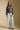 A full body front view of a woman wearing the Saltwater Luxe Ronnie Sweater on a neutral background