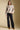 A full body front view of a woman wearing the Saltwater Luxe Ronnie Sweater on a neutral background