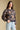 Front view of a woman wearing the Saltwater Luxe Ronnie Sweater on a neutral background with hand in pocket